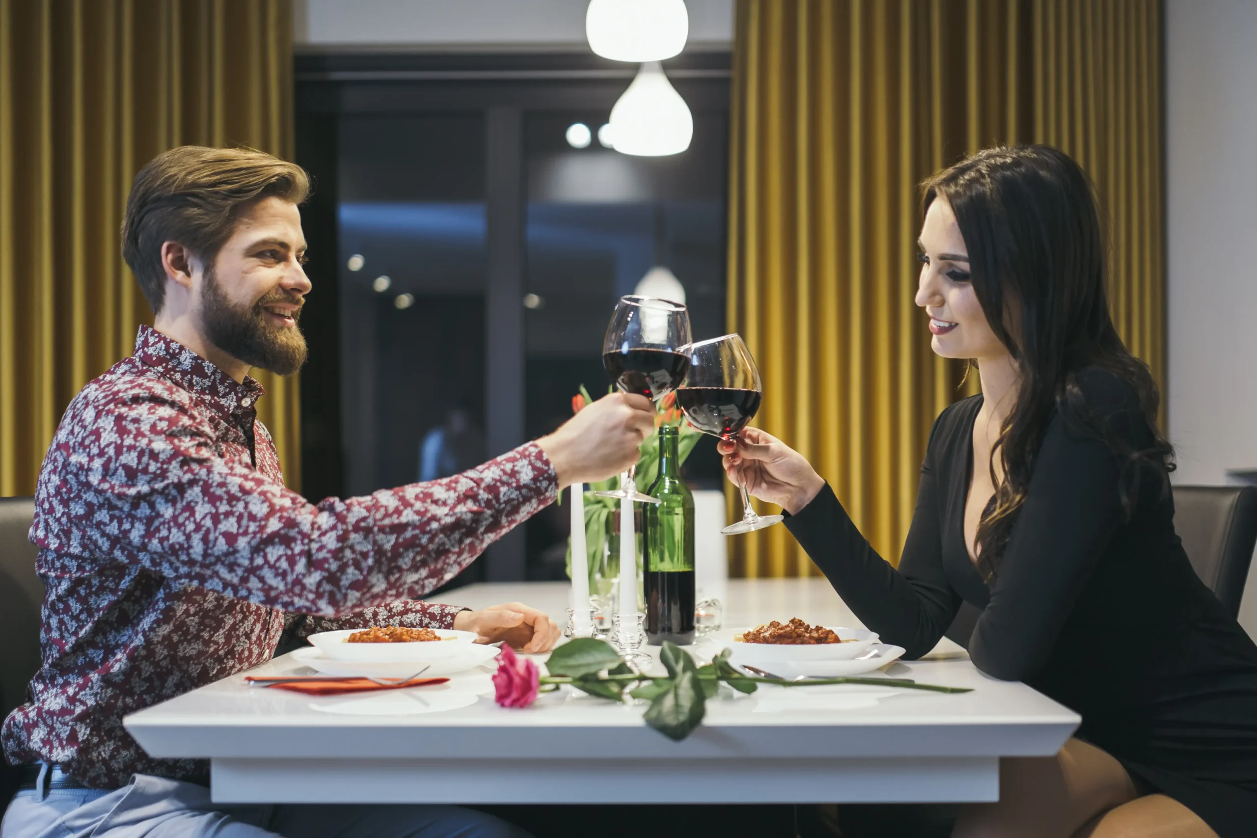 elegant-couple-clinking-with-glasses-having-dinner